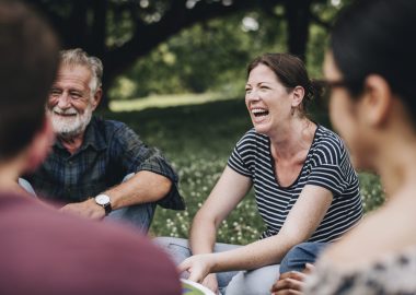 Cheerful woman in the park with her friends